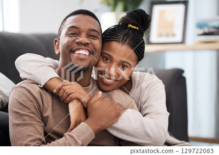 Love, hug and portrait of a happy couple on sofa in the living room of their modern home. Happiness, smile and black woman relax with husband, care and marriage on couch at the house lounge together Love, hug and portrait of a happy couple on sofa in the living room of their modern home. Happiness, smile and black woman relax with husband, care and marriage on couch at the house lounge together 129722083