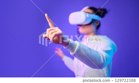 Woman hand for metaverse, virtual reality glasses and gaming for futuristic, cyber and 3d world. Gamer person finger for ar mock up, digital experience and creative cyberpunk purple background app 129722108