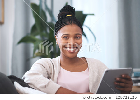 Black woman, tablet and portrait smile on sofa for social media, communication or entertainment at home. Happy African American female smiling and relaxing holding touchscreen for remote networking 129722129