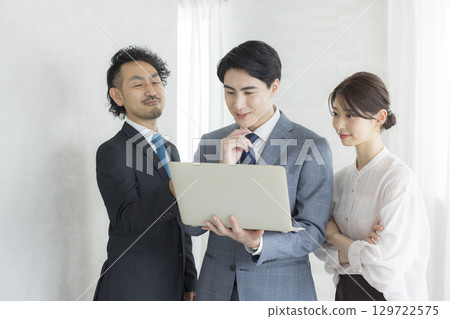 Businessman and businesswoman with laptop Businessman and businesswoman with laptop 129722575