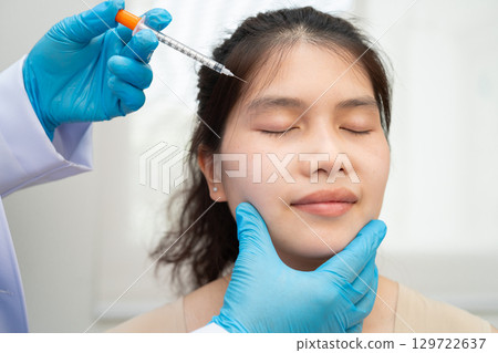 Asian woman receiving filler beauty injection. 129722637