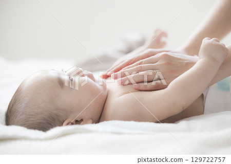 Young mother taking care of her baby 129722757