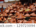 A set of tagines of many types displayed in street stalls in the souk for sale. 129723094