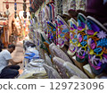Slippers or sandals of many colors hung from street stalls in Marrakech's souk 129723096