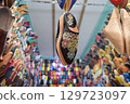 Slippers or sandals of many colors hung from street stalls in Marrakech's souk 129723097