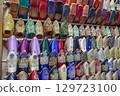Slippers or sandals of many colors hung from street stalls in Marrakech's souk 129723100