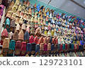 Slippers or sandals of many colors hung from street stalls in Marrakech's souk 129723101