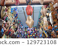 Slippers or sandals of many colors hung from street stalls in Marrakech's souk 129723108