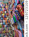 Close angle view Slippers or sandals of many colors hung from street stalls 129723109