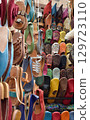 Slippers or sandals of many colors hung from street stalls in Marrakech's souk 129723110