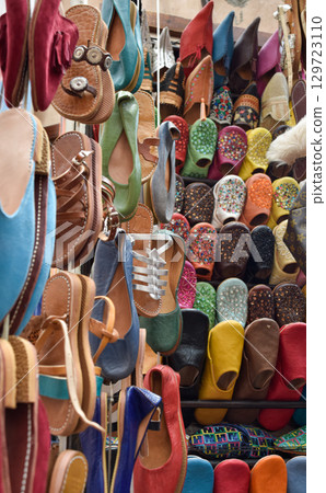 Slippers or sandals of many colors hung from street stalls in Marrakech's souk Slippers or sandals of many colors hung from street stalls in Marrakech's souk 129723110