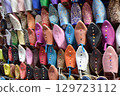 Slippers or sandals of many colors hung from street stalls in Marrakech's souk 129723112