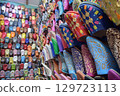 Close angle view Slippers or sandals of many colors hung from street stalls 129723113
