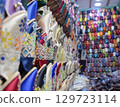 Close angle view Slippers or sandals of many colors hung from street stalls 129723114