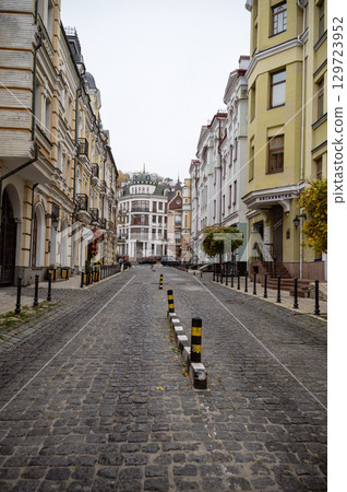 picturesque city street paved with gray cobblestones 129723952