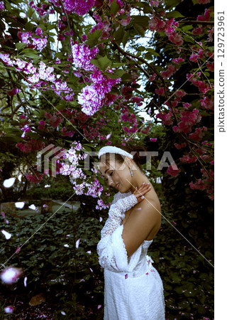 very beautiful girl among blooming sakura 129723961