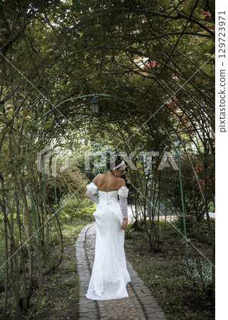 very beautiful girl bride in a long white dress very beautiful girl bride in a long white dress 129723971