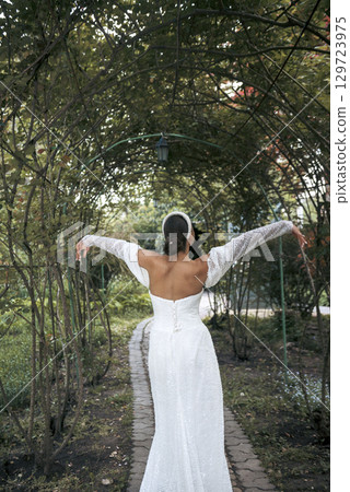 very beautiful girl bride in a long white dress very beautiful girl bride in a long white dress 129723975