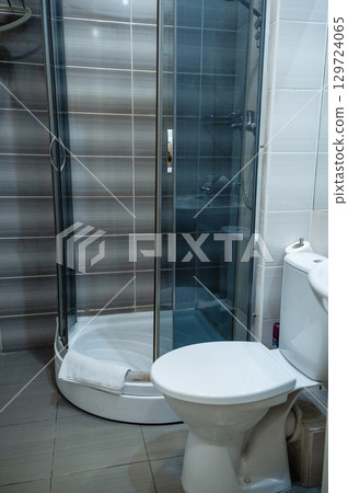 White toilet and shower stall. White toilet and shower stall. 129724065