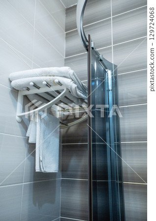 white towels hang near the shower stall white towels hang near the shower stall 129724068