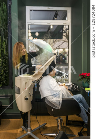 a device in a beauty salon that curls hair 129724094