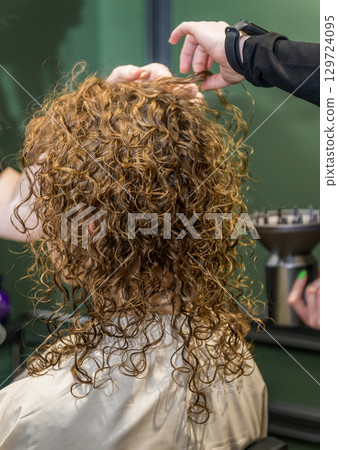 The client's hair immediately after the curling procedure 129724095