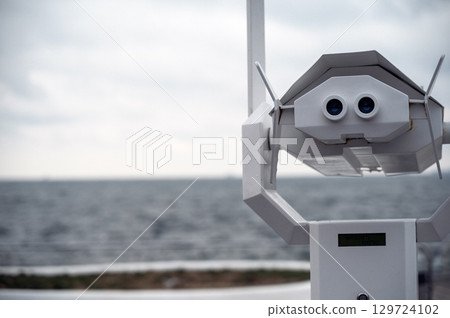 big binoculars on the viewing platform to watch the horizon of the sea 129724102