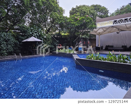 this is a swimming pool area in the hotel this is a swimming pool area in the hotel 129725144