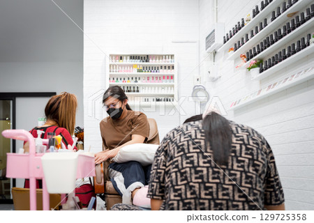 Nail technician manicure or pedicure at nail salon Nail technician manicure or pedicure at nail salon 129725358