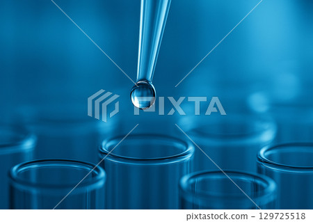 AI generated close up of a pipette releasing a clear droplet into glass test tubes with blue background conveying precision sterility and innovation in scientific research 129725518