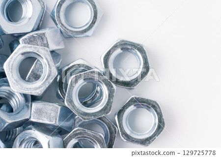 Lots of nuts on a white background Lots of nuts on a white background 129725778