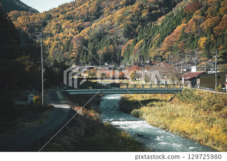 Autumn leaves on the mountains, river and bridge Autumn leaves on the mountains, river and bridge 129725980