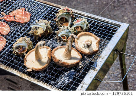 Food grilled on a barbecue grill 129726101