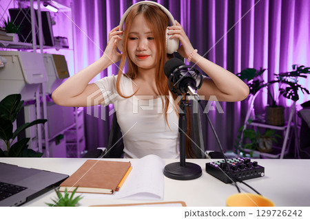 Podcast host recording professional audio for streaming broadcast and digital content creation in modern studio Podcast host recording professional audio for streaming broadcast and digital content creation in modern studio 129726242