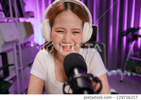 Podcast host recording professional audio for streaming broadcast and digital content creation in modern studio Podcast host recording professional audio for streaming broadcast and digital content creation in modern studio 129726257