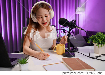 Podcast host recording professional audio for streaming broadcast and digital content creation in modern studio Podcast host recording professional audio for streaming broadcast and digital content creation in modern studio 129726284