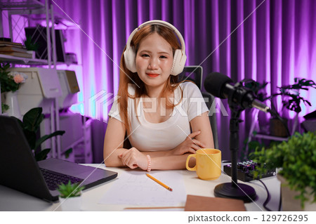 Podcast host recording professional audio for streaming broadcast and digital content creation in modern studio Podcast host recording professional audio for streaming broadcast and digital content creation in modern studio 129726295
