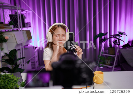 Podcast host recording professional audio for streaming broadcast and digital content creation in modern studio Podcast host recording professional audio for streaming broadcast and digital content creation in modern studio 129726299