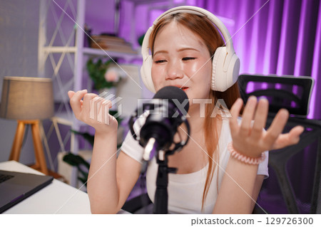 Podcast host recording professional audio for streaming broadcast and digital content creation in modern studio Podcast host recording professional audio for streaming broadcast and digital content creation in modern studio 129726300