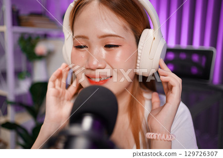 Podcast host recording professional audio for streaming broadcast and digital content creation in modern studio Podcast host recording professional audio for streaming broadcast and digital content creation in modern studio 129726307