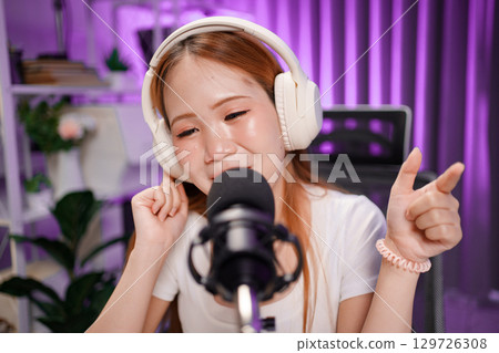 Podcast host recording professional audio for streaming broadcast and digital content creation in modern studio Podcast host recording professional audio for streaming broadcast and digital content creation in modern studio 129726308