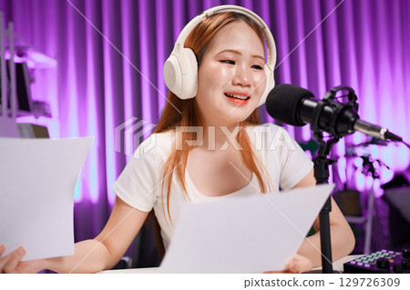 Podcast host recording professional audio for streaming broadcast and digital content creation in modern studio Podcast host recording professional audio for streaming broadcast and digital content creation in modern studio 129726309