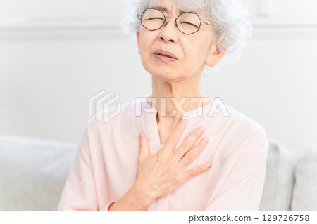 Senior woman with esophagitis Senior woman with esophagitis 129726758