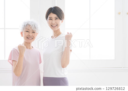 Young and senior women doing yoga, healthy image Young and senior women doing yoga, healthy image 129726812