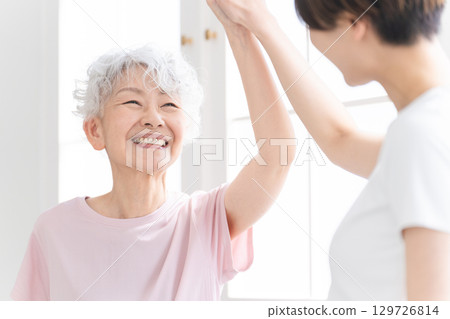 Young and senior women doing yoga, healthy image 129726814