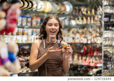 Woman standing in souvenir shop Woman standing in souvenir shop 129726844