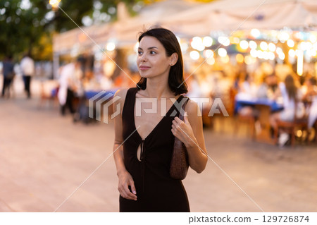 Young woman walking through urban street in Barcelona Young woman walking through urban street in Barcelona 129726874