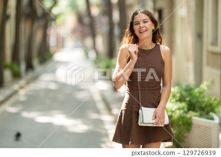Woman walking in the park in summer 129726939