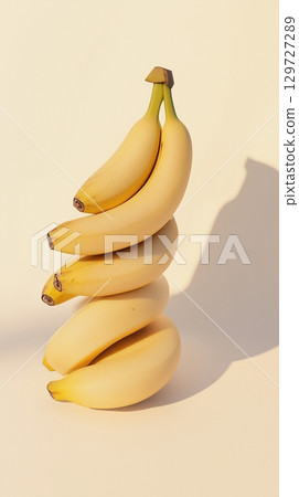 A stack of banana fruit balancing on top with pink solid background 129727289