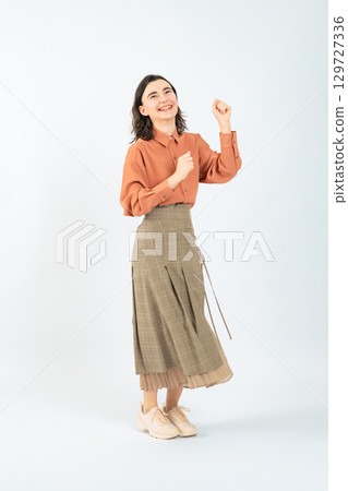 Full body photo of a dancing white woman 129727336
